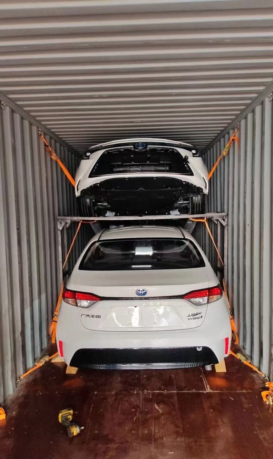 Two vehicles lashed in a 40HQ container on a two-tier rack
